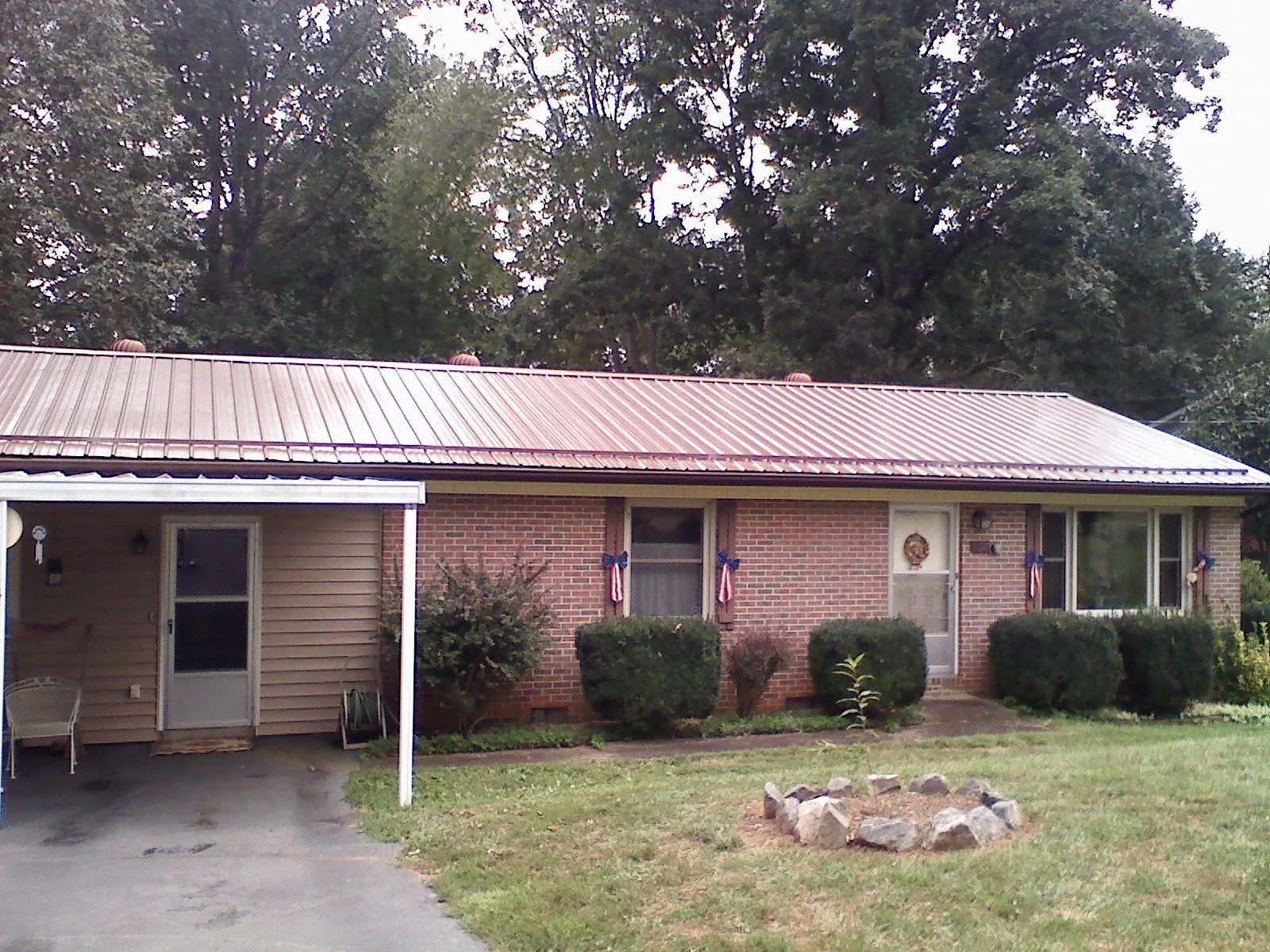 Bronze metal roof and carport on a brick ranch home — Roof Repair work by our crew in Santa Rosa